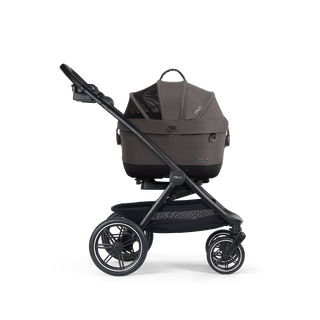 A Maeve iso Wind 5x Pet Car Seat closed, in ashen, and attached to the Roscoe Trek 2.0 Pet Stroller Frame from a side profile.