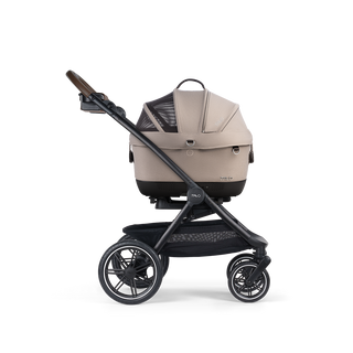 A Maeve iso Wind 5x Pet Car Seat closed, in fawn, and attached to the Roscoe Trek 2.0 Pet Stroller Frame from a side profile.