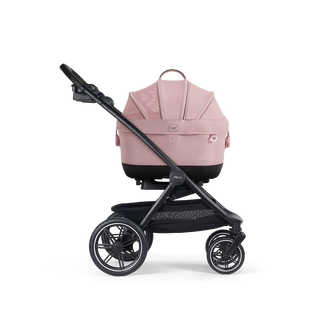 A Maeve iso Wind 5x Pet Car Seat closed, in sakura, and attached to the Roscoe Trek 2.0 Pet Stroller Frame from a side profile.