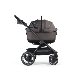 A Maeve iso Wind 6x Pet Car Seat closed, in ashen, and attached to the Roscoe Trek 2.0 Pet Stroller Frame from a side profile.