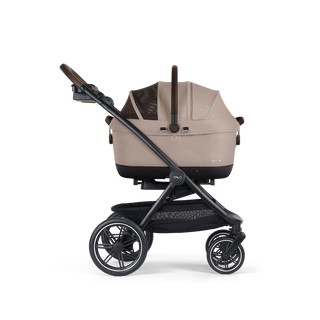 A Maeve iso Wind 6x Pet Car Seat closed, in fawn, and attached to the Roscoe Trek 2.0 Pet Stroller Frame from a side profile.
