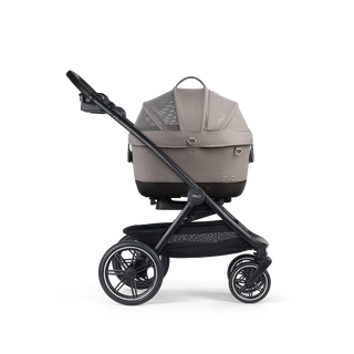 A Maeve iso Wind 5x Pet Car Seat closed, in merle, and attached to the Roscoe Trek 2.0 Pet Stroller Frame from a side profile.