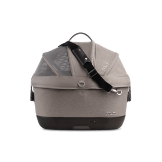 A Maeve iso 5x Wind Pet Car Seat in the fashion merle from the side with the canopy closed