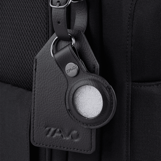 A Kamella Pet Backpack and Car Seat, in onyx, zoomed in on the luggage tag and tracking device holder.