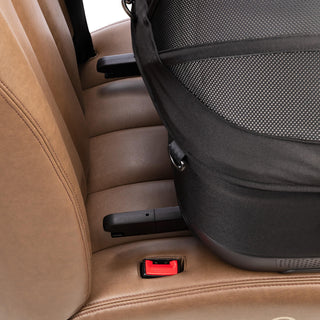 A close up image of the Maeve iso ISOFIX latches about to attach to the vehicle anchor points of a car seat bench.