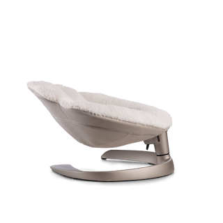 Side view of a white plush pet bed with gray underside on a brushed bronze c-shaped frame sitting at the lowest, reclining angle