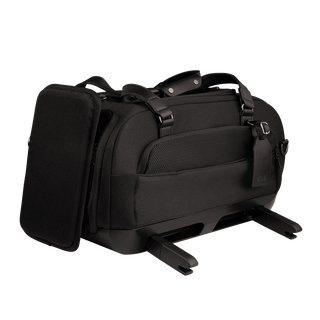 three-quarter view of compact, black pet car seat with two carry handles on top featuring attached side impact protection, extended ISOFIX latches, and black luggage tag - view 4