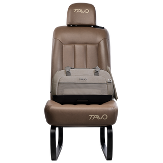Side view of compact, gray pet car seat with two carry handles on top attached to a brown vehicle seat with attached side impact protection  - view 4