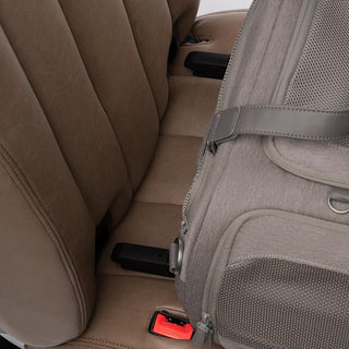 Close up view of ISOFIX latches of gray pet carrier aimed for the vehicle's rigid latch anchor bars on a brown vehicle seat - view 5