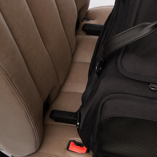 Close up view of ISOFIX latches aimed for the vehicle's rigid latch anchor bars on a brown vehicle seat - view 6