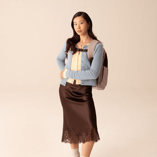 Woman wearing Kamella pet backpack with padded straps and magnetic buckles.