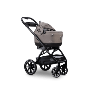 A Maeve iso 5x Wind travel system in the fashion merle with the right side of the car seat canopy open 
