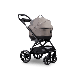 A Maeve iso 5x Wind travel system in the fashion merle with the car seat canopy closed 